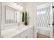 Bathroom featuring a modern vanity with marble countertop, an elegant mirror, and a step-in shower at 4521 W Buffalo St, Chandler, AZ 85226