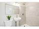 Bathroom with pedestal sink and step-in shower features modern fixtures and updated shower tile at 4521 W Buffalo St, Chandler, AZ 85226
