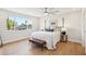 Bedroom with a large bed, ceiling fan, and view of neighborhood at 4521 W Buffalo St, Chandler, AZ 85226