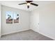 Bright bedroom featuring neutral carpet, a sliding door closet, and a window with palm tree views at 4521 W Buffalo St, Chandler, AZ 85226