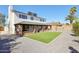 Back exterior with a covered patio overlooking the well-kept gravel and artificial turf in backyard at 4521 W Buffalo St, Chandler, AZ 85226