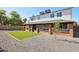 Back exterior with a covered patio overlooking the well-kept gravel and artificial turf in backyard at 4521 W Buffalo St, Chandler, AZ 85226