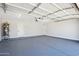 A spacious garage with epoxy floors, white walls, and ample overhead lighting showcasing functionality at 4521 W Buffalo St, Chandler, AZ 85226