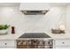 Close-up of stovetop featuring stainless steel knobs and marble countertops at 4521 W Buffalo St, Chandler, AZ 85226