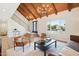 Bright living room featuring a vaulted ceiling, wood beams, and modern light fixtures at 4521 W Buffalo St, Chandler, AZ 85226