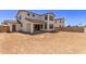 Backyard with two-story home, covered patio, desert landscaping, and a block fence at 5016 W Brown St, Glendale, AZ 85302