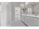 Bathroom with glass shower, dual sink vanity and walk-in closet access at 5016 W Brown St, Glendale, AZ 85302