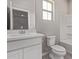 Clean bathroom with white vanity, toilet, and shower-tub combo at 5016 W Brown St, Glendale, AZ 85302