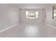 Bright, empty room with tile flooring, recessed lighting, and large windows at 5016 W Brown St, Glendale, AZ 85302
