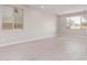 Bright, empty room with tile floors, recessed lighting, and large windows at 5016 W Brown St, Glendale, AZ 85302