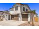 Two-story home with two-car garage, desert landscaping, and covered entry at 5016 W Brown St, Glendale, AZ 85302