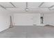 Clean and spacious garage with concrete flooring, overhead lighting, and utility connections at 5016 W Brown St, Glendale, AZ 85302