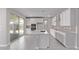 Bright modern kitchen with stainless appliances, white cabinets, central island and gray tile floor at 5016 W Brown St, Glendale, AZ 85302