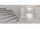 Carpeted staircase leading to a tiled entryway and view of a sunlit room at 5016 W Brown St, Glendale, AZ 85302