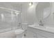 Bathroom featuring modern tiling around the tub and a modern vanity with a granite countertop at 5129 W Windrose Dr, Glendale, AZ 85304
