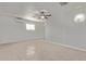 Bedroom with neutral tile flooring, ceiling fan and mini-split AC unit at 5129 W Windrose Dr, Glendale, AZ 85304