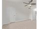 Neutral bedroom featuring tile floors, a ceiling fan, and an ensuite bathroom at 5129 W Windrose Dr, Glendale, AZ 85304
