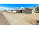 Single-story house with a spacious two-car garage and a well-kept front yard at 5129 W Windrose Dr, Glendale, AZ 85304