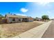 Inviting single-story home featuring a well-manicured front yard and stylish neutral color palette at 5129 W Windrose Dr, Glendale, AZ 85304