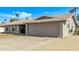 Single-story house with a spacious two-car garage and a well-kept front yard at 5129 W Windrose Dr, Glendale, AZ 85304