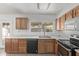 Kitchen featuring wood cabinets, stainless steel appliances, and a view to the backyard at 5129 W Windrose Dr, Glendale, AZ 85304