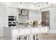 Stylish kitchen with stainless steel appliances, white cabinets, and a large central island at 5250 E Deer Valley Dr # 440, Phoenix, AZ 85054