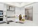 Bright modern kitchen features white cabinets, stainless steel appliances, and a herringbone backsplash at 5250 E Deer Valley Dr # 440, Phoenix, AZ 85054