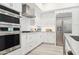 Well-equipped kitchen with stainless steel appliances, white cabinets, and modern lighting at 5250 E Deer Valley Dr # 440, Phoenix, AZ 85054