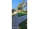 Well-manicured front yard featuring lush green grass and a paved sidewalk under a bright blue sky at 5550 N 12Th St # 2, Phoenix, AZ 85014