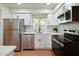 Modern kitchen with stainless steel appliances, white cabinets, and a bright window at 5550 N 12Th St # 2, Phoenix, AZ 85014