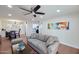 Comfortable living room featuring neutral tones, a ceiling fan, and adjacent dining area at 5550 N 12Th St # 2, Phoenix, AZ 85014