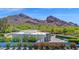 Aerial view of a modern desert home highlighting the mountain views and lush landscaping at 6321 N Camelback Manor Dr, Paradise Valley, AZ 85253