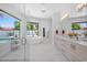 Bright bathroom featuring a modern tub, dual vanity, and walk-in glass shower with views of the outdoor pool at 6321 N Camelback Manor Dr, Paradise Valley, AZ 85253