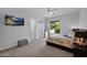 Bright bedroom with a mounted TV, outdoor view, and a comfortable seating area at 6321 N Camelback Manor Dr, Paradise Valley, AZ 85253