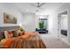 Bright bedroom with vibrant bedding, a modern ceiling fan, and a comfortable sitting area by the window at 6321 N Camelback Manor Dr, Paradise Valley, AZ 85253