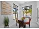 Cozy dining area with glass table, views of the pool and backyard, and modern décor at 6321 N Camelback Manor Dr, Paradise Valley, AZ 85253