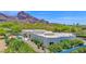 Stunning architectural home with mountain views, pool, and lush landscaping creates a private desert oasis at 6321 N Camelback Manor Dr, Paradise Valley, AZ 85253