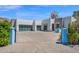 Contemporary home with a clean modern aesthetic, spacious driveway, and desert landscaping at 6321 N Camelback Manor Dr, Paradise Valley, AZ 85253