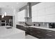 Modern kitchen features stylish white and wood cabinets, a gray backsplash, and stainless steel appliances at 6321 N Camelback Manor Dr, Paradise Valley, AZ 85253