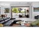 Comfortable living room with sleek black furniture, and a seamless transition to the outdoor pool area at 6321 N Camelback Manor Dr, Paradise Valley, AZ 85253