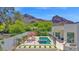 Inviting pool area with lounge chairs and mountain views for ultimate relaxation and entertainment at 6321 N Camelback Manor Dr, Paradise Valley, AZ 85253