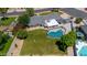 Aerial view showcases a backyard with a large pool, grass, a shed, and desert landscaping at 737 E 7Th Pl, Mesa, AZ 85203