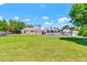 Large backyard featuring a grassy lawn, mature trees, and a swimming pool at 737 E 7Th Pl, Mesa, AZ 85203