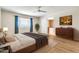 Bright bedroom with a queen bed, hardwood floors, natural light, and view to connected bathroom at 737 E 7Th Pl, Mesa, AZ 85203
