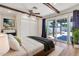 Relaxing bedroom featuring wood floors, a ceiling fan, and sliding glass doors to patio at 737 E 7Th Pl, Mesa, AZ 85203