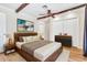 Inviting bedroom with a beamed ceiling, wood floors, and soft, natural lighting at 737 E 7Th Pl, Mesa, AZ 85203