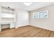 Neutral bedroom with wood floors, built-in desk, and closet at 737 E 7Th Pl, Mesa, AZ 85203