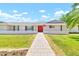 Charming single-story home with a vibrant red front door, manicured lawn, and inviting walkway at 737 E 7Th Pl, Mesa, AZ 85203