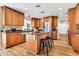 Well-lit kitchen with stainless steel appliances, granite countertops, and a central island with seating at 737 E 7Th Pl, Mesa, AZ 85203