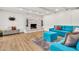 Bright living room features a stone fireplace, wood floors, and a comfortable blue sofa at 737 E 7Th Pl, Mesa, AZ 85203